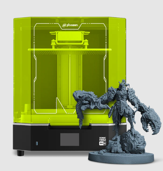 The Phrozen Sonic Mega 8K S large-format resin 3D printer featuring a bright green acrylic cover, shown next to a large, highly detailed 3D printed monster miniature