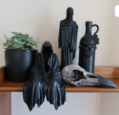 Black 3D printed sitting ghost statue.  