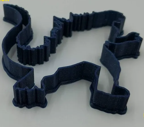 A dark blue 3D printed cookie cutter shaped like the classic silhouette of Mechagodzilla.