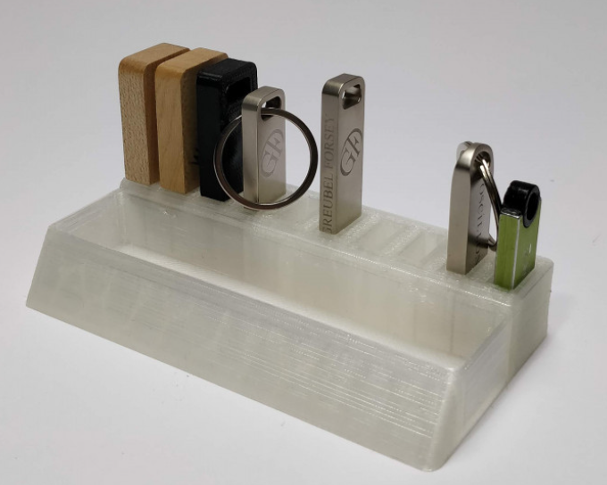 A clear, translucent 3D printed USB holder with a minimalist design