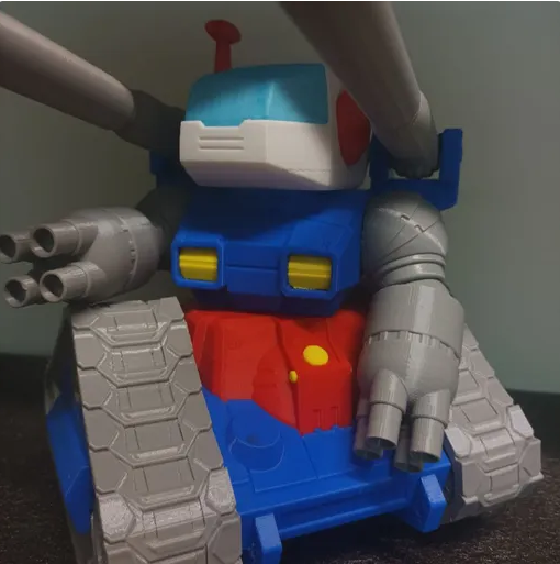 A 3D-printed RX-75 Guntank SD Jumbo Figure featuring blue, red, white, and grey parts with tank treads and shoulder cannons.
