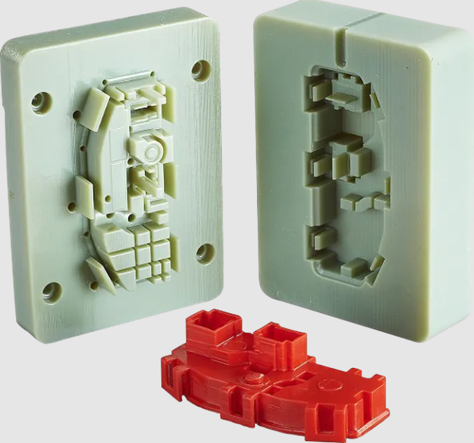 Two halves of a light green 3D-printed casting mold displayed behind the final intricate red cast plastic part