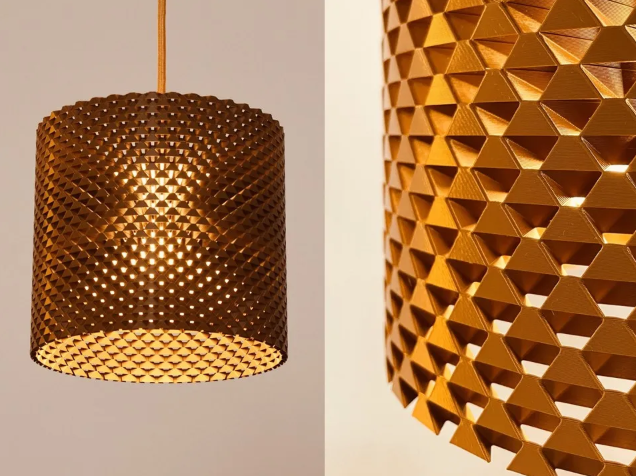 A 3D printed translucent Art Deco style lampshade with a symmetrical, tiered geometric design illuminated from within