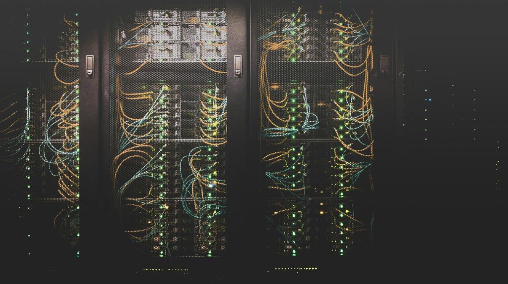 Illuminated server racks and cables representing cloud render farms