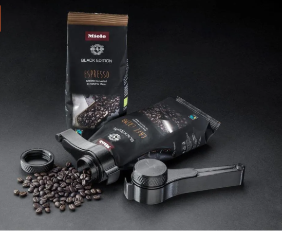3D printed Miele coffee bag clip with built-in pouring spout on an espresso bag