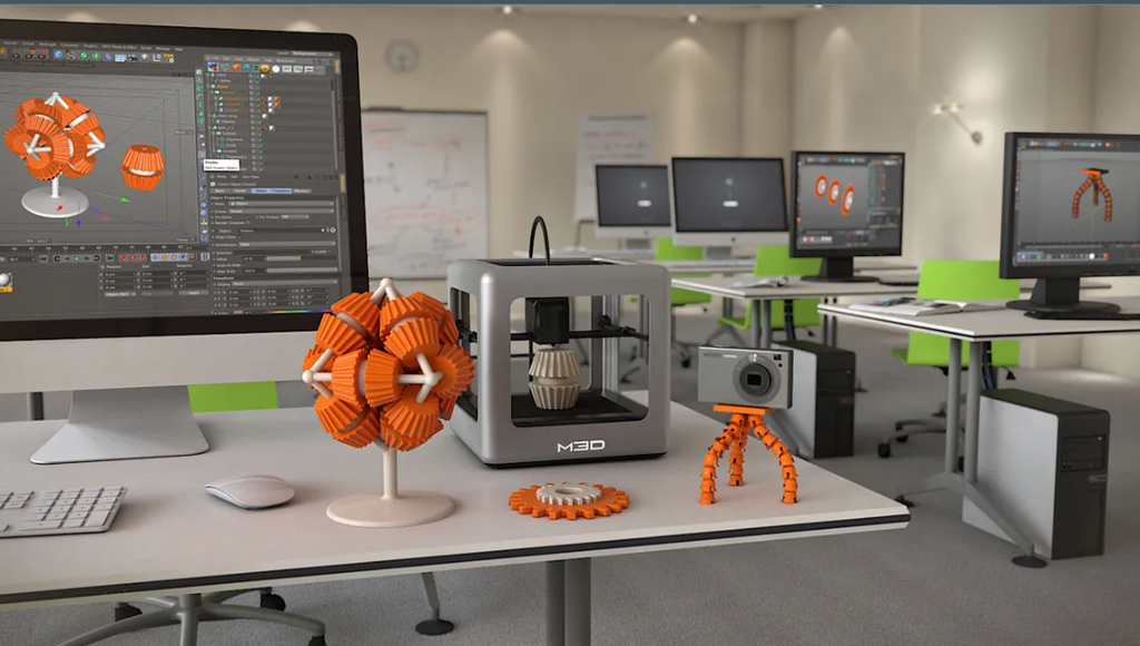 A workspace featuring desktop computers with CAD software, a central 3D printer, and various 3D printed objects like geometric spheres and miniature cameras.