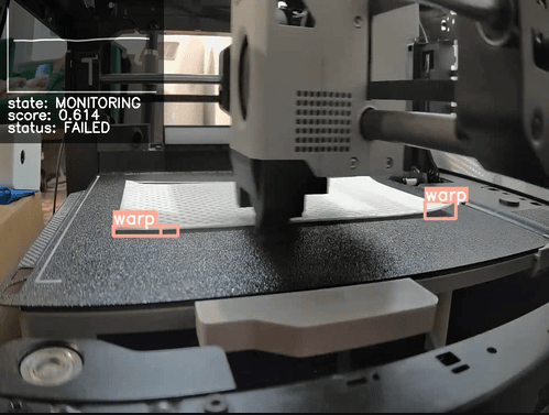 A SimplyPrint AI camera feed identifying and labeling a warped white 3D print on the build plate.