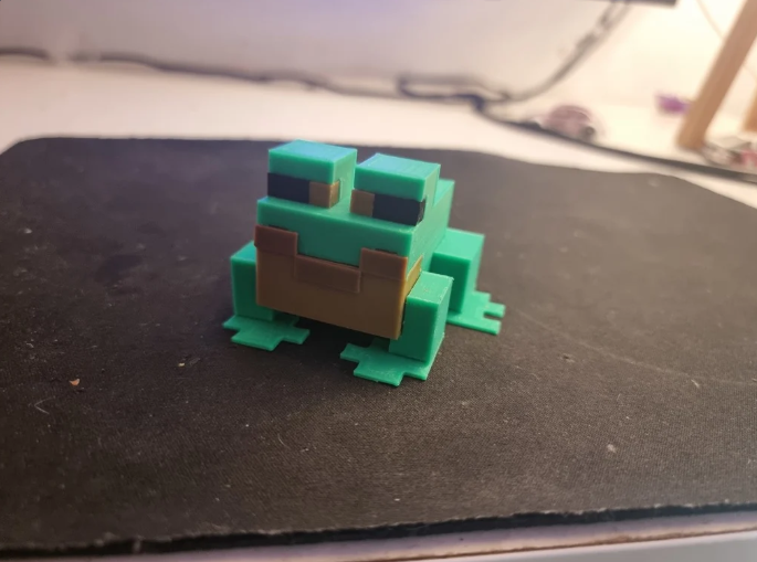 Charming 3D printed Minecraft frog figure with an in-game blocky aesthetic.