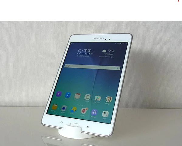 A clean, white single-piece 3D-printed stand with smooth curves holding a white tablet in portrait mode.