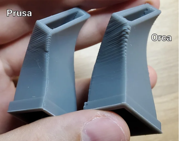 A side-by-side physical print quality comparison showing a gray 3D printed part sliced with PrusaSlicer next to one sliced with OrcaSlicer.
