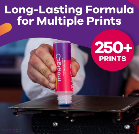 A hand applying Magigoo 3D printing adhesive from a purple tube directly onto a black print bed.