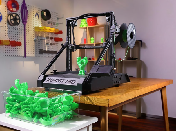 The Infinity3D 2-in-1 Belt 3D Printer on a wooden desk