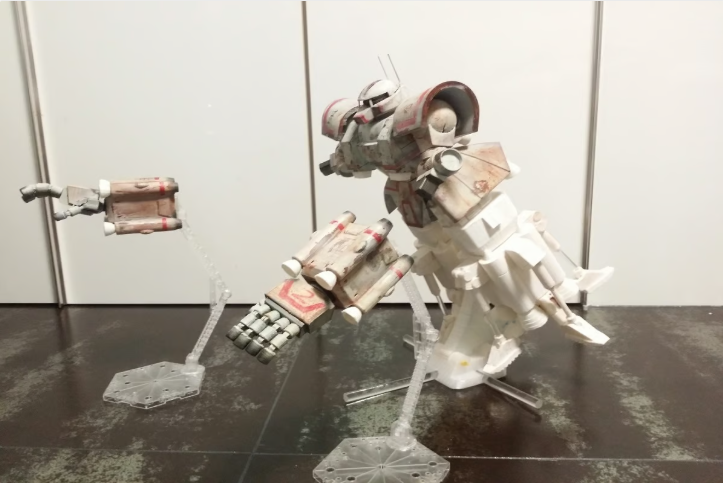 A white and grey 3D-printed High Mobility Type Zaku II model displayed on clear stands in a dynamic hovering pose.