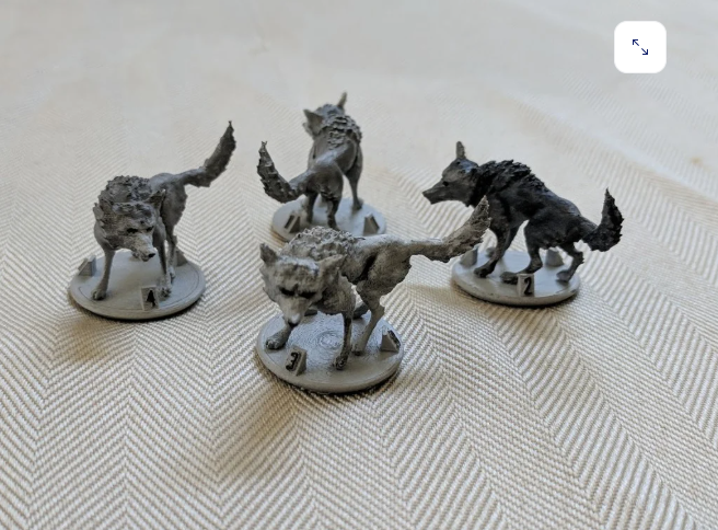 Four grey 3D-printed Gloomhaven hound miniatures on circular bases.