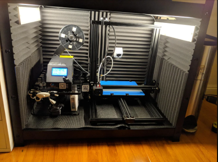 A 3D printer sitting on a heavy concrete paving stone