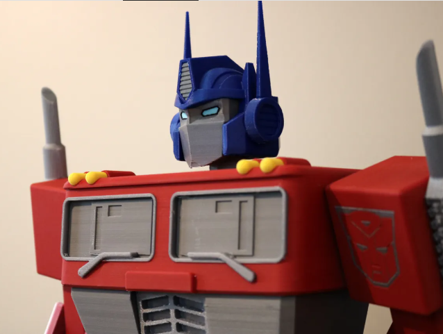 Close-up of a large 3D printed Optimus Prime bust, utilizing multi-material colored