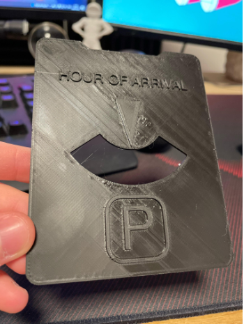 A black 3D printed card showing surface bumps, blobs, and raised lines caused by a Cura ironing over-extrusion issue.