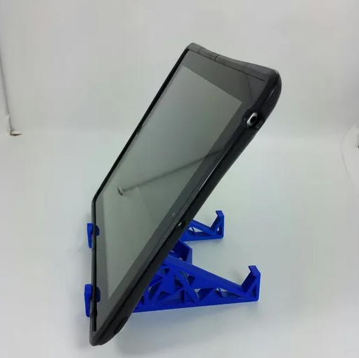 A blue 3D-printed stand featuring a geometric triangle-based frame supporting a black tablet at an ergonomic viewing angle.