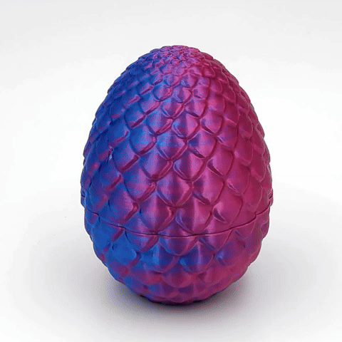 A highly detailed, black 3D-printed dragon egg featuring a textured, scaly surface with subtle glitter embedded in the filament.
