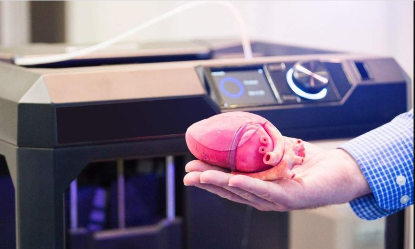 A man holding a 3D printed heart