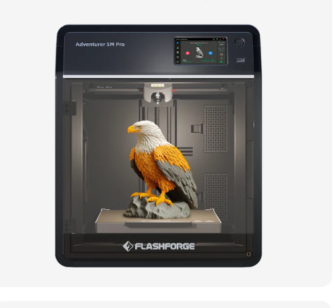 An enclosed Flashforge Adventurer 5M Pro 3D printer with a large clear door showcasing a vibrant 3D printed eagle model.