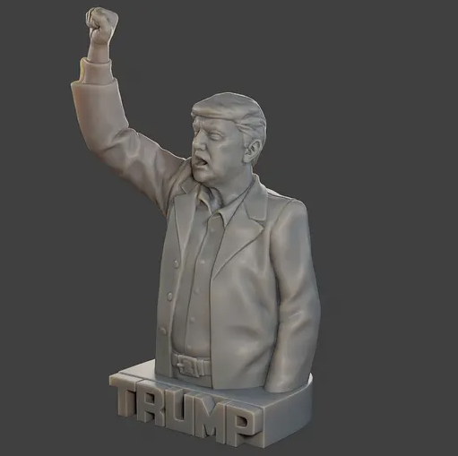3D printed dynamic sculpture of Donald Trump with a raised fist, mounted on a custom base displaying the word "TRUMP".