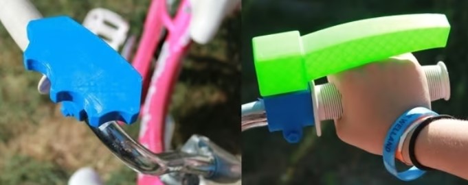 Two side-by-side images showing blue and green 3D printed assistive grip devices mounted onto bicycle handlebars