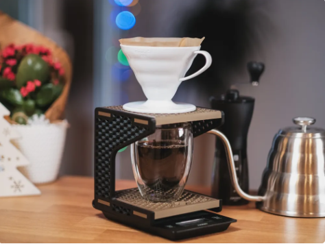 3D printed pour-over coffee stand holding a white dripper and glass mug on a scale