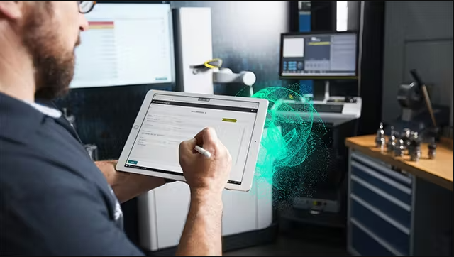 Technician using a tablet with augmented reality overlay for predictive equipment maintenance