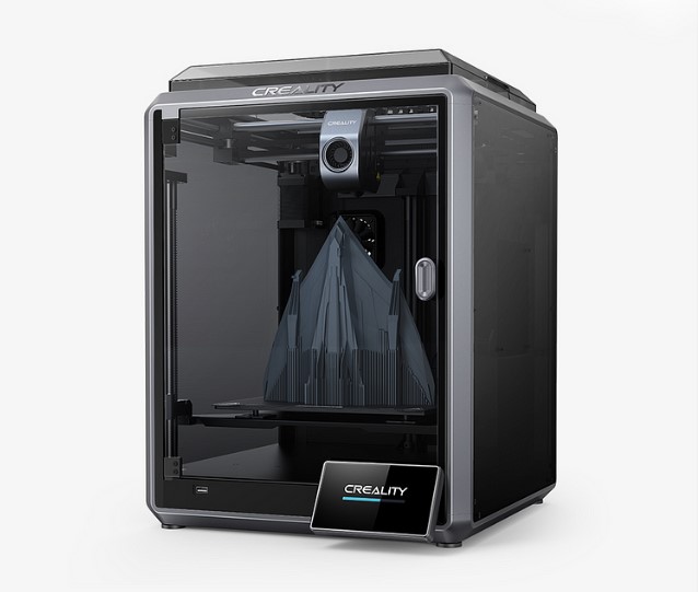 A Creality K1 Max 3D printer with its side panels open, showing a large, sharp-angled 3D printed model on the build plate