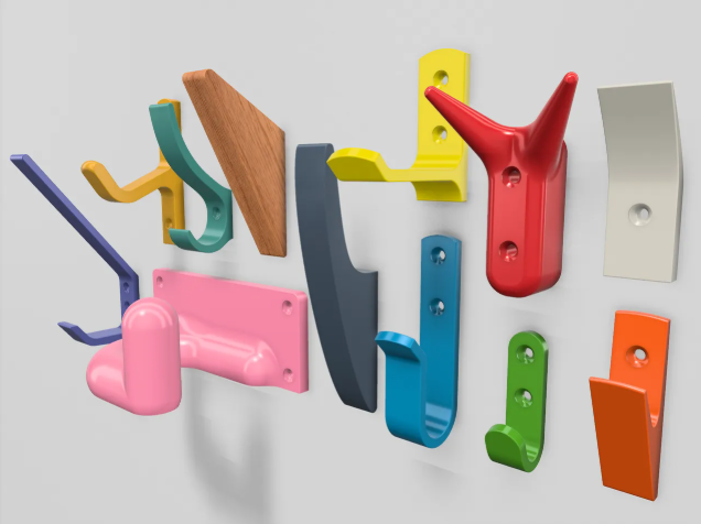 A colorful collection of 3D printed wall hooks in various shapes, sizes, and mounting styles, showcasing the versatility of the MaxT design.