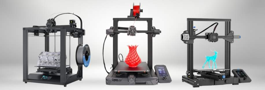 Three different Creality 3D printers displaying finished prints, including an engine block, a red vase, and a blue deer, on their build plates.