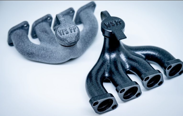 Two black 3D printed automotive manifold components highlighting the smooth surface finish and mechanical durability of polypropylene (PP) material.