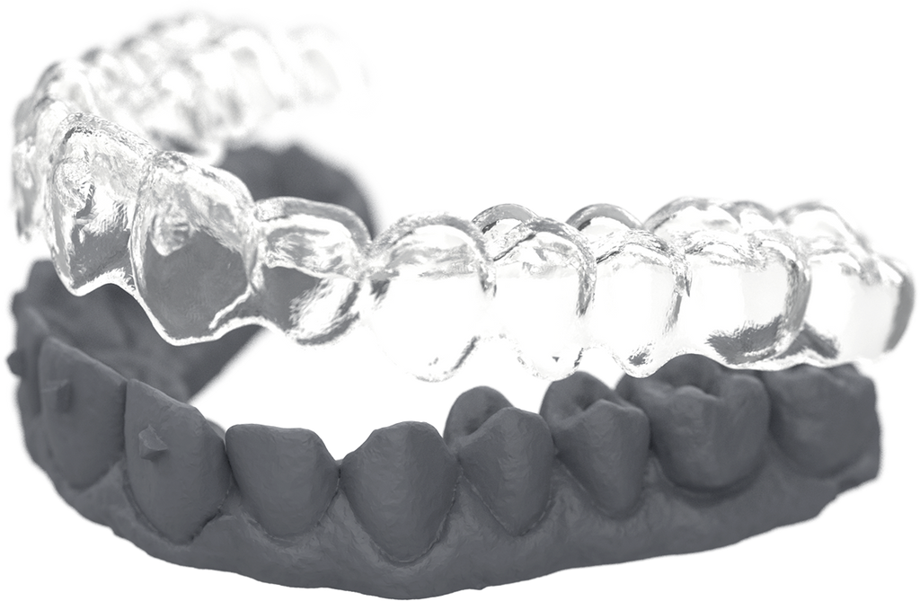 3D printed dental aligner model with a clear upper tray and a grey lower mold.