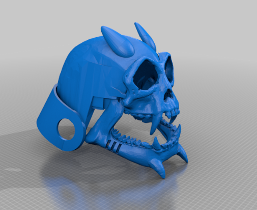 A bright blue 3D-printed skull-like helmet with sharp teeth, horns, and intricate bone details.