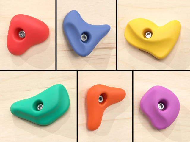 A collage of six colorful, small climbing holds (red, blue, yellow, green, orange, and purple)