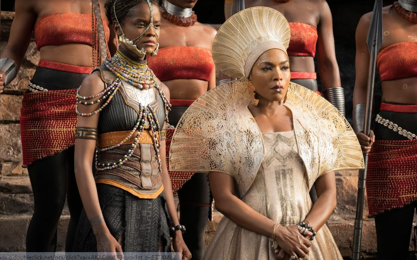 Queen Ramonda from Marvel's Black Panther wearing her iconic, intricate golden shoulder mantle and headpiece