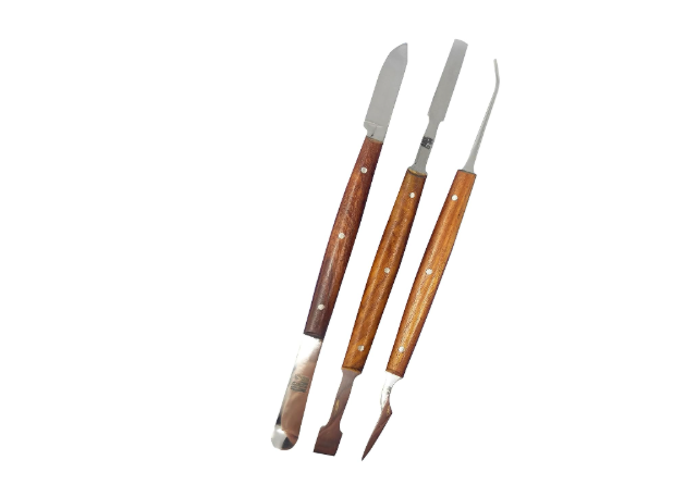 A set of three precision knives and scrapers featuring polished wooden handles. 