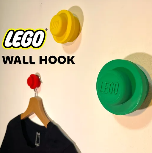A bright yellow, minimalist 3D printed simple hook securely mounted to a white wall with a single Phillips head screw.