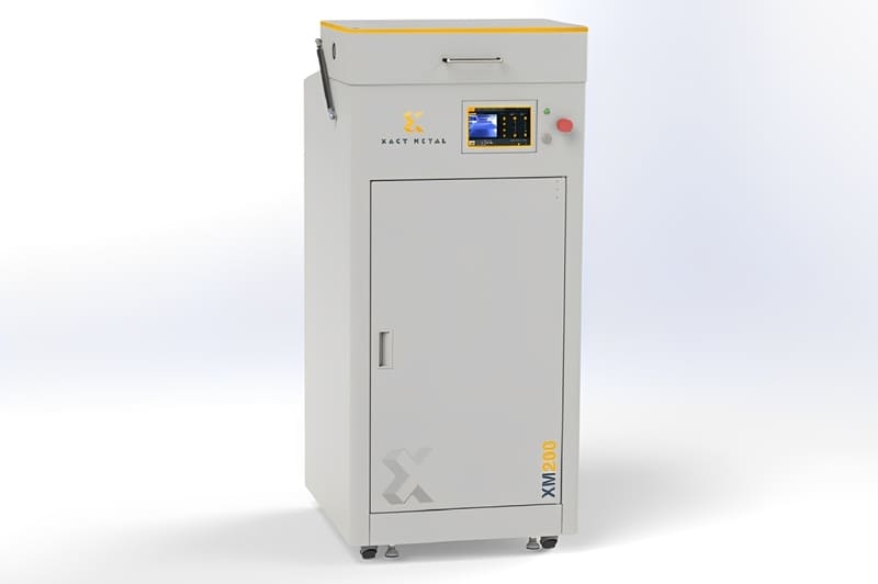 The Xact Metal XM200C, a compact, grey gantry-mounted powder-bed fusion 3D printer.  