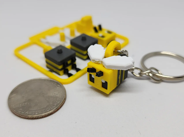 Small, blocky 3D printed Minecraft bee figure attached to a keychain.