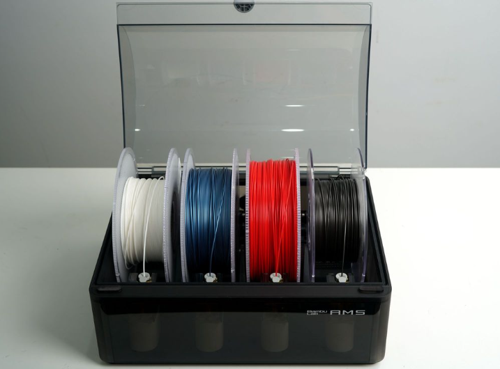 Close-up of the Bambu Lab AMS internal roller bays actively feeding a spool of brightly colored PLA filament into the motorized system.