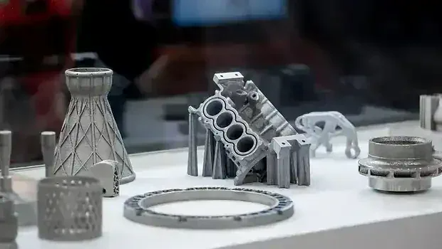 Collection of metal 3D printed engine components and industrial parts on display