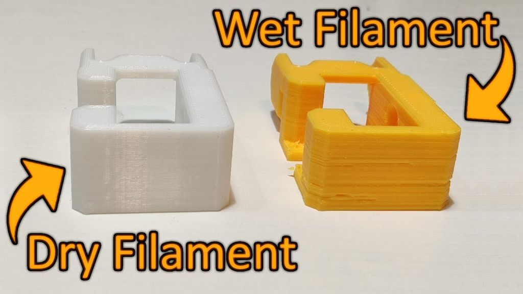 A white 3D print with smooth layers labeled 'Dry Filament' next to a yellow print with bubbly, uneven layers labeled 'Wet Filament'