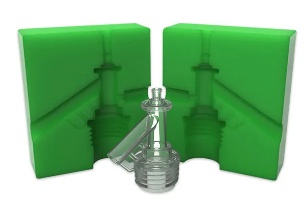 Two green 3D-printed master pattern mold halves standing behind a clear, highly detailed cast resin component.