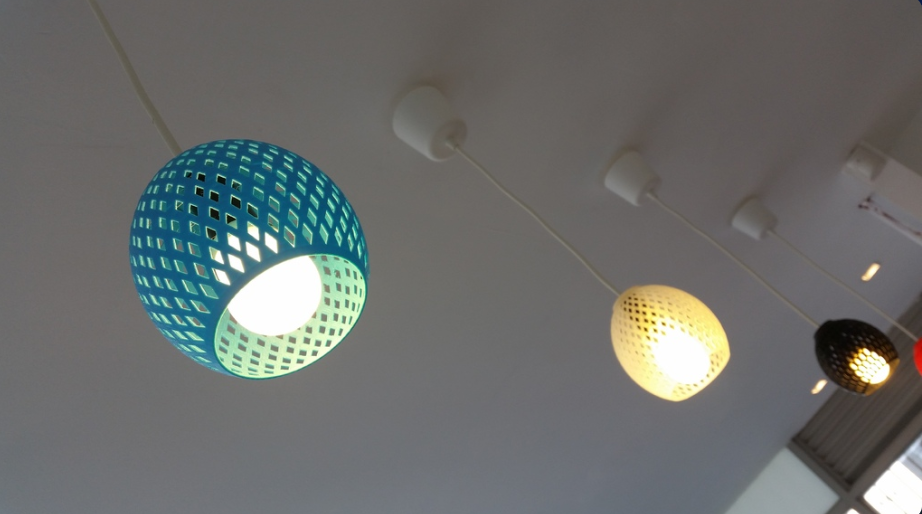 Three hanging 3D printed classic lampshades in turquoise, white, and black, featuring a diamond-cut geometric pattern.