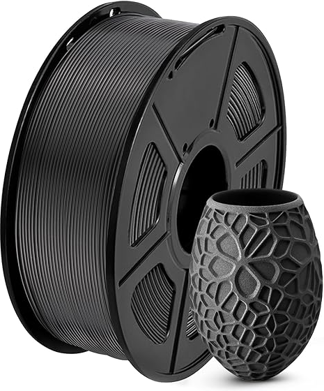 A roll of black PLA filament next to a 3D printed intricate geometric vase.