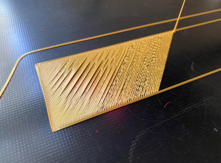 A close-up comparison of a 3D print’s first layer on a textured build plate