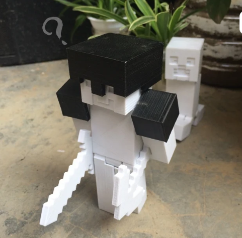 3D printed Minecraft Steve articulated figure featuring a segmented head, torso, arms, and legs