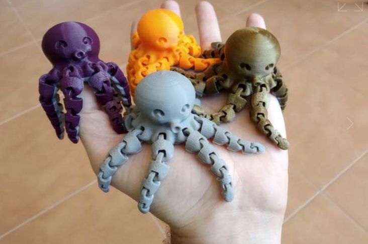 Hand holding 3D printed octopus